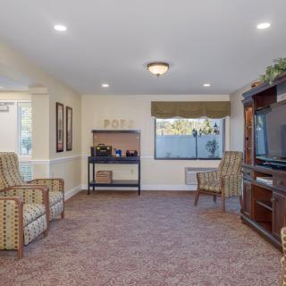 A cozy living room with comfortable seating and a large TV.