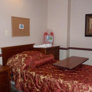 A simple bedroom with a single bed and decorative elements.