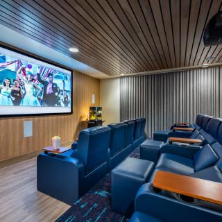 A cozy home theater with comfortable seating and a large projector screen.