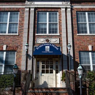 The elegant entrance of a historic brick building, showcasing classic architectural features.