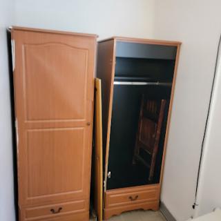 Two wooden wardrobes in a minimalistic bedroom setting.