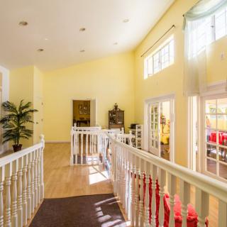 A bright hallway with large windows and decorative elements.