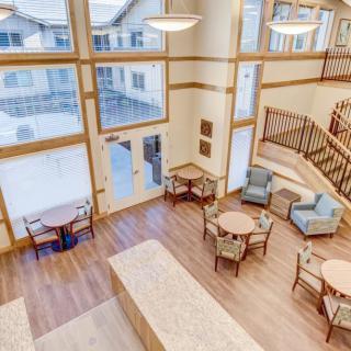 A spacious lobby with modern furnishings, featuring large windows and ample natural light.