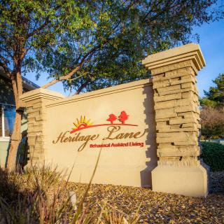 A decorative entrance sign for Heritage Lane, an independent senior living community.