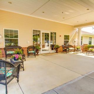 A spacious outdoor patio with comfortable seating and decorative flower pots.