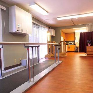 A physical therapy room equipped with parallel bars for rehabilitation exercises.