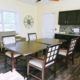 A cozy dining area with modern furniture and a wooden floor.
