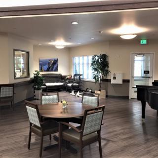 A well-lit dining area with tables and chairs arranged neatly.
