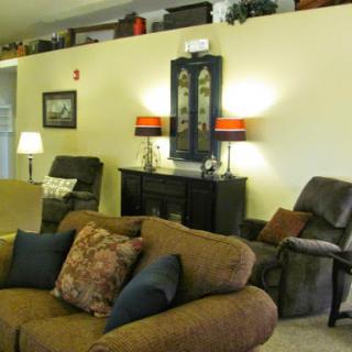 A cozy living room featuring a comfortable sofa, recliner, and tasteful decor.