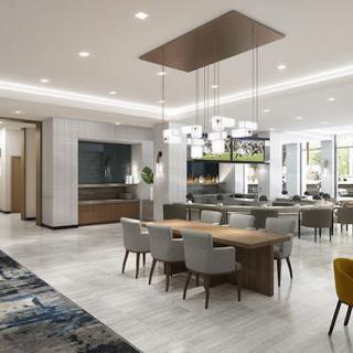 A spacious and modern dining area with elegant chandeliers.