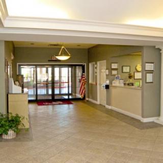 A spacious lobby area with reception desk and entrance doors.