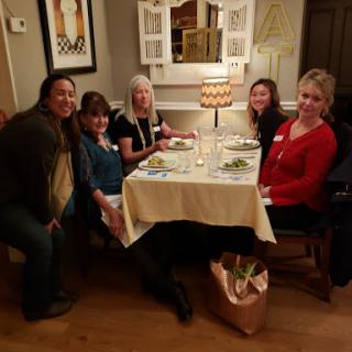 A cheerful group enjoying dinner together at a cozy restaurant.