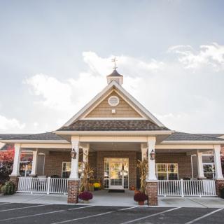 A charming building with a peaked roof and inviting entrance under a clear sky.