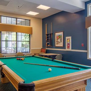 A cozy game room featuring a pool table ready for play.
