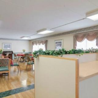 A well-lit room with arranged chairs and tables, featuring decorative elements.