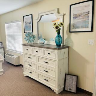 A stylish dresser with a mirror and decorative elements, enhancing the interior of a cozy living space.