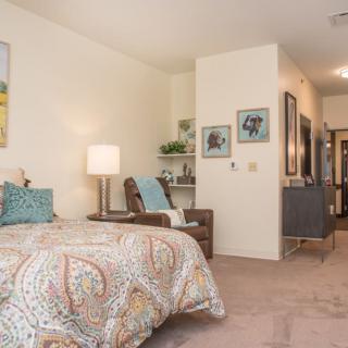 A cozy bedroom with stylish decor and furniture.