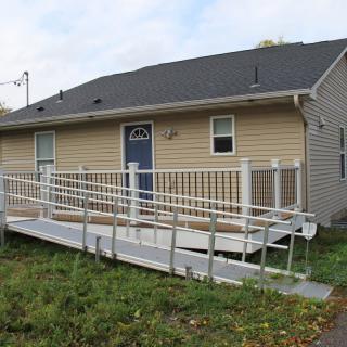A house with an accessibility ramp leading to the front door.
