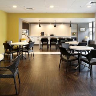 A modern cafe interior with sleek furnishings and ample natural light.