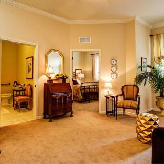 A cozy living room with traditional furnishings and warm lighting.
