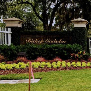 The elegant entrance to Bishop's Garden, adorned with vibrant landscaping.