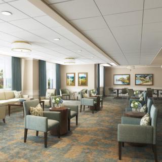 A spacious, well-lit lobby with comfortable seating and decorative artwork on the walls.