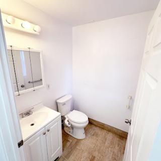A clean and minimalistic bathroom design featuring essential amenities.