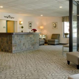 A spacious lobby with a reception desk and comfortable seating.