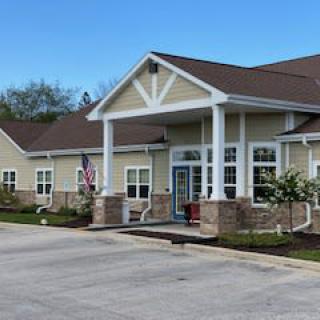 A single-story building with a welcoming entrance and landscaped yard.