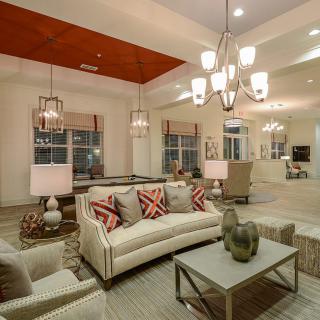 A modern living room with elegant lighting and comfortable seating.