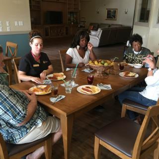 A group of people enjoying a meal together at a dining table.