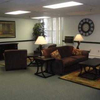 A cozy living room with a sofa set, lamps, and decorative items.