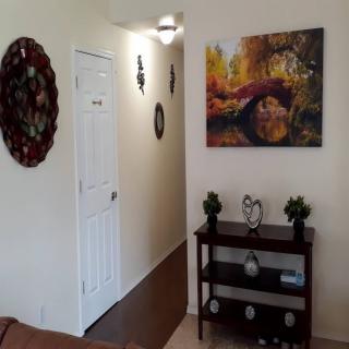 A cozy hallway with decorative elements and a scenic painting on the wall.