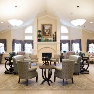 Elegant living room with a central fireplace and comfortable seating arrangement.