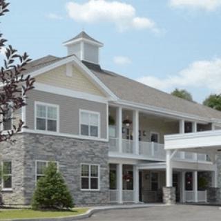 A two-story residential building with stone and siding facade.