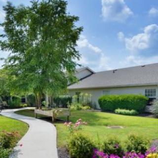 Beautifully landscaped garden surrounding a house with a winding pathway.