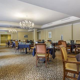 Elegant dining area with chandeliers and classic furniture.