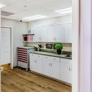 A clean and organized medical office interior with cabinets and a countertop.