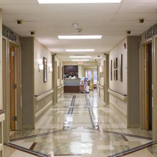 A clean and well-lit hospital corridor leading to a reception area.