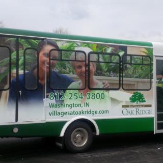 A bus featuring an advertisement for a senior living community.