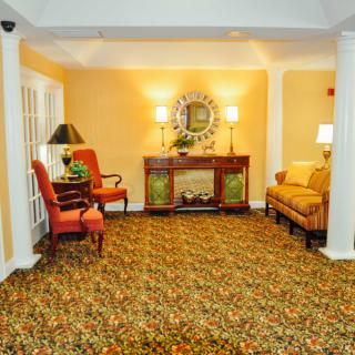 A cozy living room with warm lighting, featuring elegant furniture and decor.