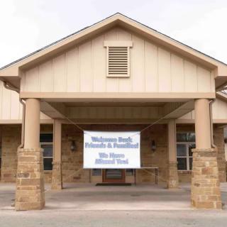 A building entrance with a welcome banner displayed.