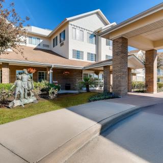 A modern residential building with a welcoming entrance and landscaped surroundings.