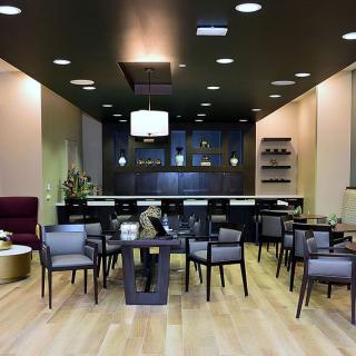A modern lounge area with stylish seating and a bar setup.
