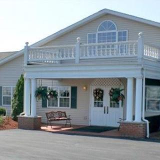 A two-story building with a welcoming entrance and decorative balcony.