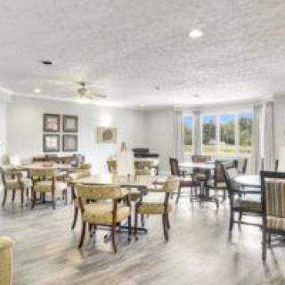 A spacious and bright dining area with tables and chairs arranged neatly.