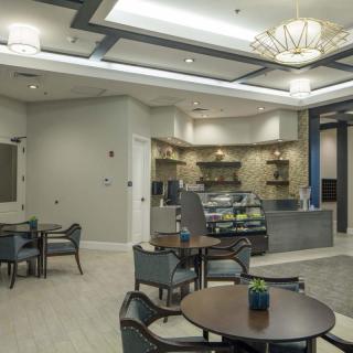 A modern caf interior with elegant lighting and comfortable seating arrangements.