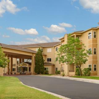 The exterior view of a hotel with a welcoming entrance and surrounding greenery.