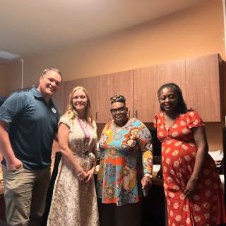 A joyful gathering of friends in a kitchen setting.
