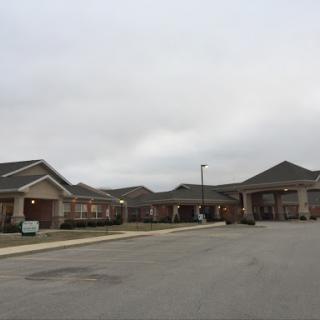 A quiet residential area featuring modern buildings under a cloudy sky.
